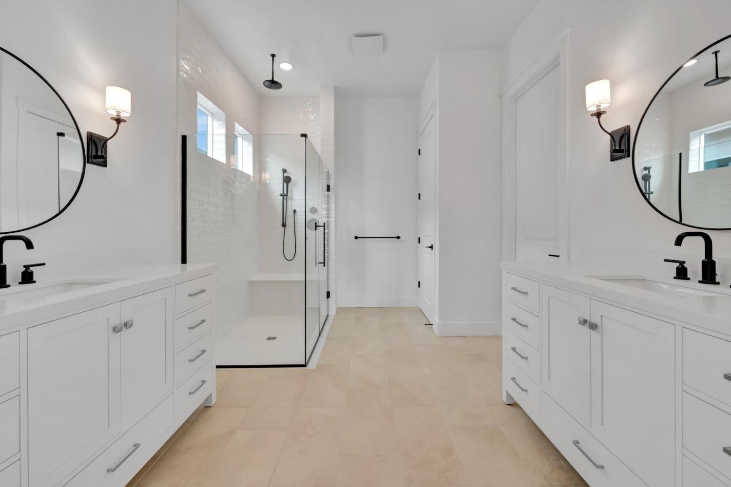 4327 Hooded Crow Way Rancho Cordova, CA 95742 - Photo 51 of 58 a spacious bathroom with a mirror a double vanity sink and a mirror