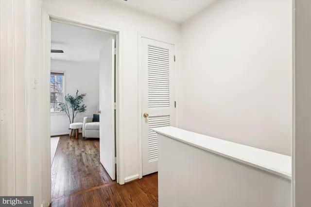 a view of an entryway with wooden floor and door