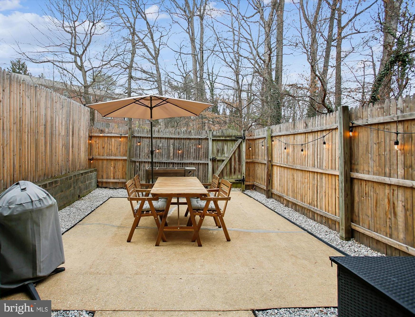 5818 Torington Drive, Unit 859 Springfield, VA 22152 - Photo 28 of 46 a view of backyard with furniture and umbrella