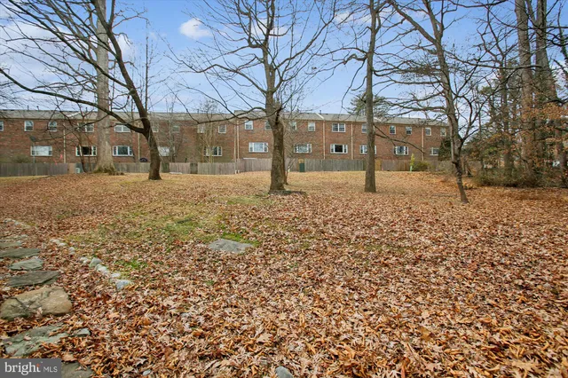 a view of a roof deck with table and chairs under an umbrella