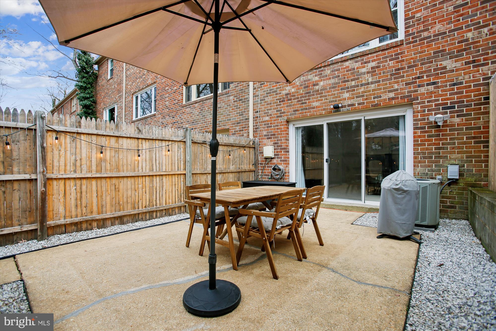 5818 Torington Drive, Unit 859 Springfield, VA 22152 - Photo 33 of 46 a view of a roof deck with table and chairs under an umbrella