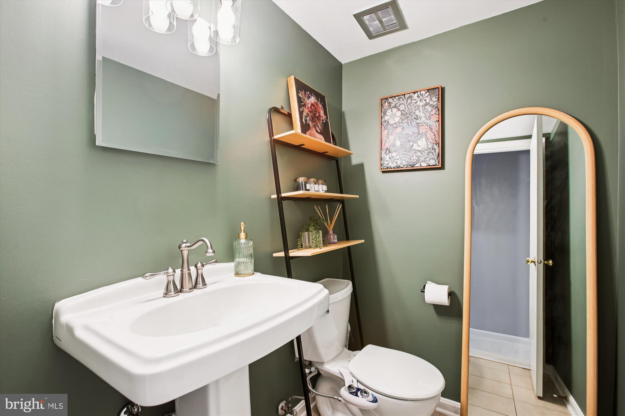 5818 Torington Drive, Unit 859 Springfield, VA 22152 - Photo 35 of 46 a bathroom with a toilet a sink and mirror