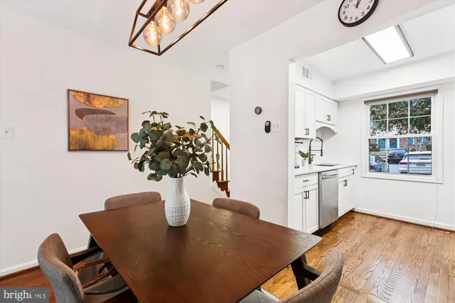 a dining room with furniture and wooden floor
