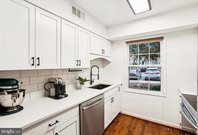 a view of kitchen with furniture and wooden floor
