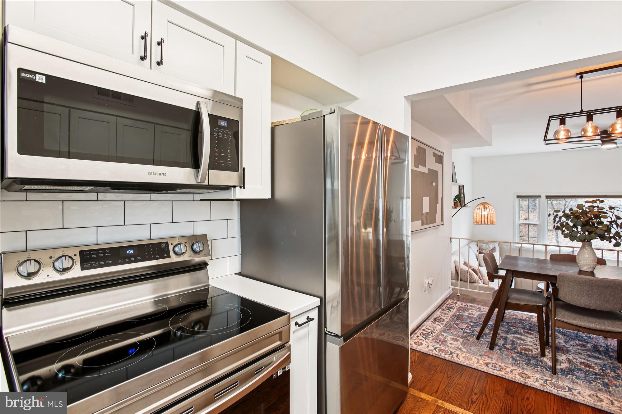 5818 Torington Drive, Unit 859 Springfield, VA 22152 - Photo 7 of 46 a kitchen with stainless steel appliances kitchen island granite countertop a refrigerator and a stove top oven