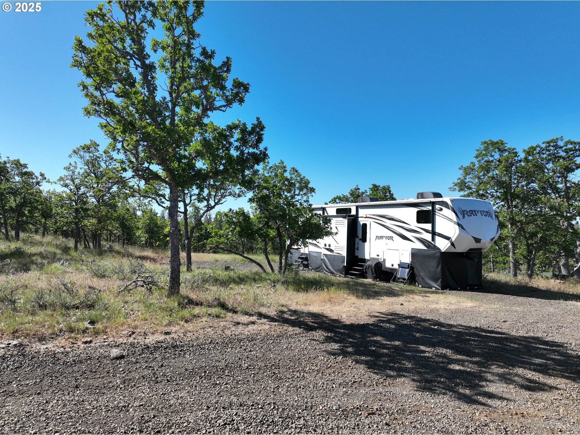 104 Jenkins Creek Road Goldendale, WA 98620 - Photo 13 of 45 a view of a park that has large trees and a wooden fence