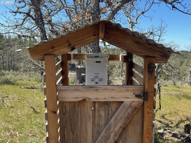 104 Jenkins Creek Road Goldendale, WA 98620 - Photo 31 of 45 a view of a wooden house with a large tree