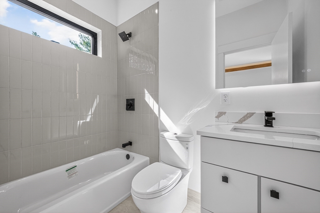 15 Bird Hill Road Lexington, MA 02421 - Photo 24 of 34 a bathroom with a toilet a sink and a bathtub