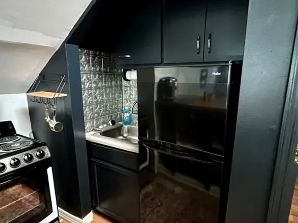 a kitchen with a refrigerator and a stove