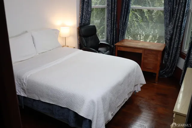 a bed sitting in a bedroom next to a window