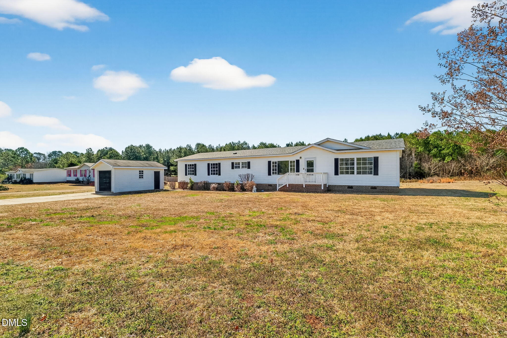 10015 Smith Road Middlesex, NC 27557 - Photo 3 of 48 a front view of a house with a garden
