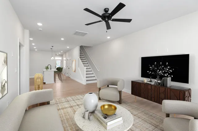 a living room with furniture and a wooden floor