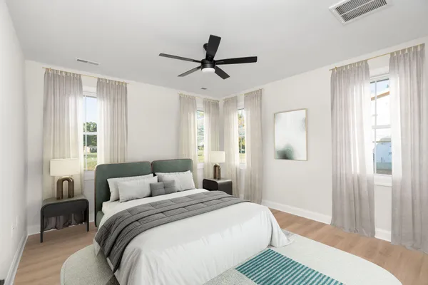 a bedroom with a large bed and a chandelier