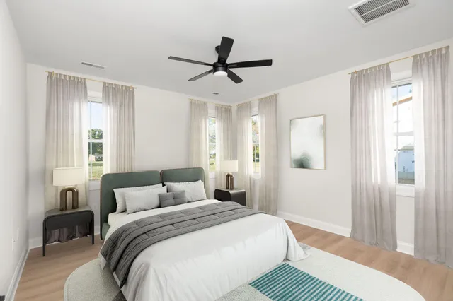 a bedroom with a large bed and a chandelier