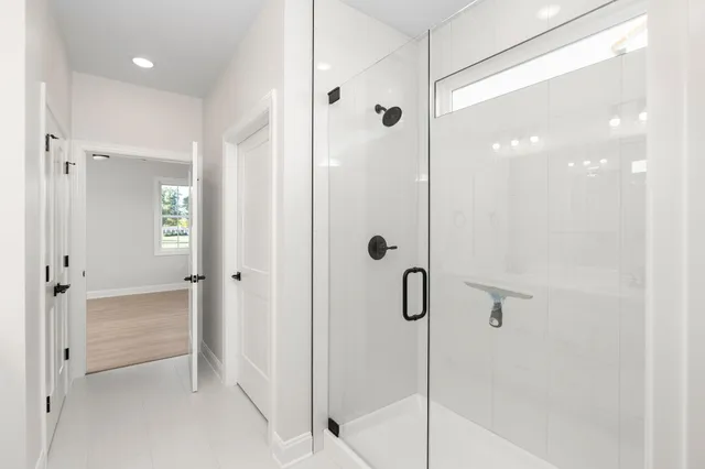 a bathroom with a shower and a glass door