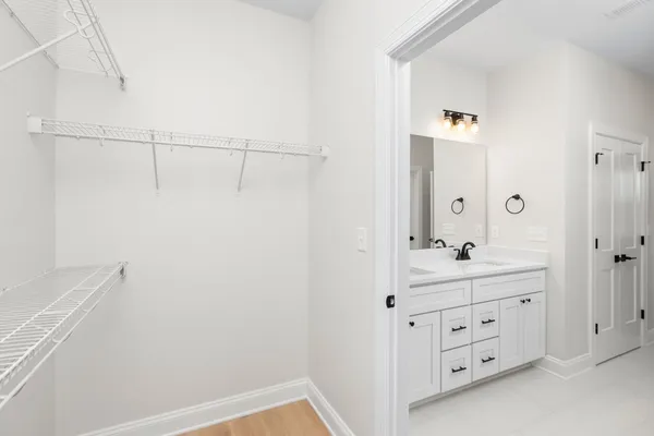 a bathroom with a double vanity sink a toilet and a mirror
