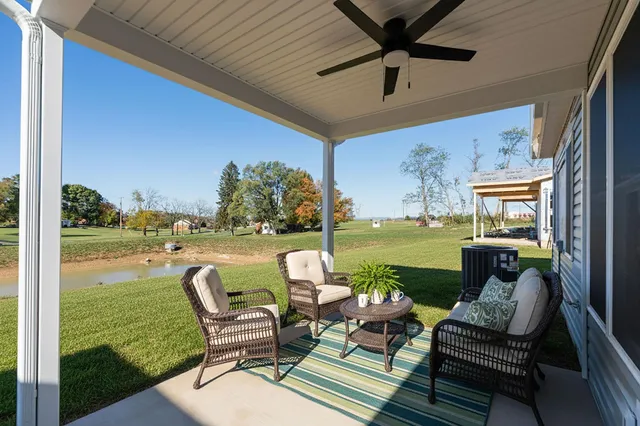 a balcony with couple of chairs and a table