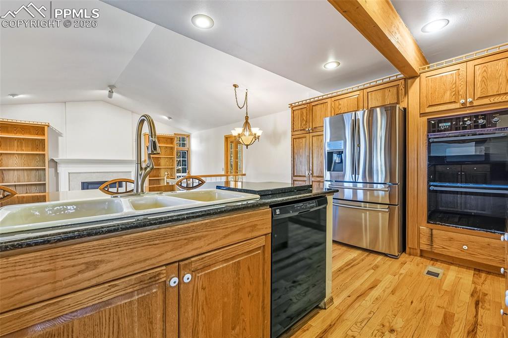 435 East Woodmen Road Colorado Springs, CO 80919 - Photo 17 of 50 a kitchen with stainless steel appliances sink stove refrigerator and cabinets