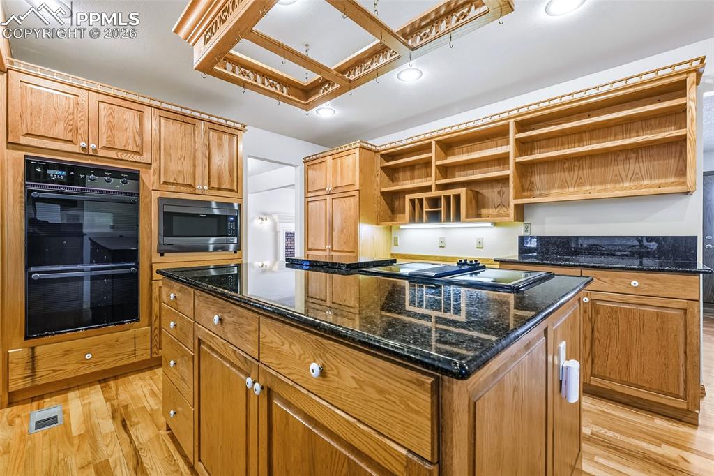 435 East Woodmen Road Colorado Springs, CO 80919 - Photo 18 of 50 a kitchen with stainless steel appliances granite countertop a stove and a sink