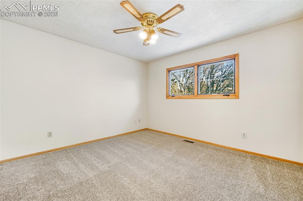 435 East Woodmen Road Colorado Springs, CO 80919 - Photo 21 of 50 an empty room with window and a ceiling fan
