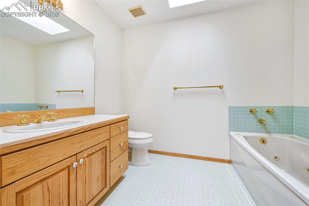 435 East Woodmen Road Colorado Springs, CO 80919 - Photo 22 of 50 a bathroom with a granite countertop sink a toilet and bathtub