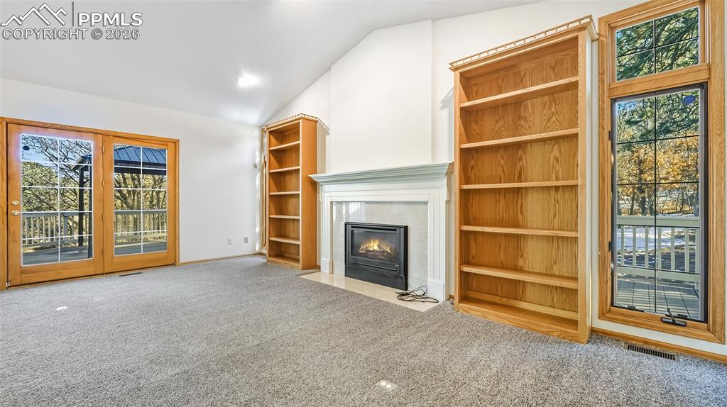 435 East Woodmen Road Colorado Springs, CO 80919 - Photo 4 of 50 a view of an empty room with a fireplace and a window