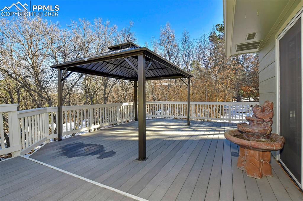 435 East Woodmen Road Colorado Springs, CO 80919 - Photo 8 of 50 a view of deck with wooden floor and outdoor seating