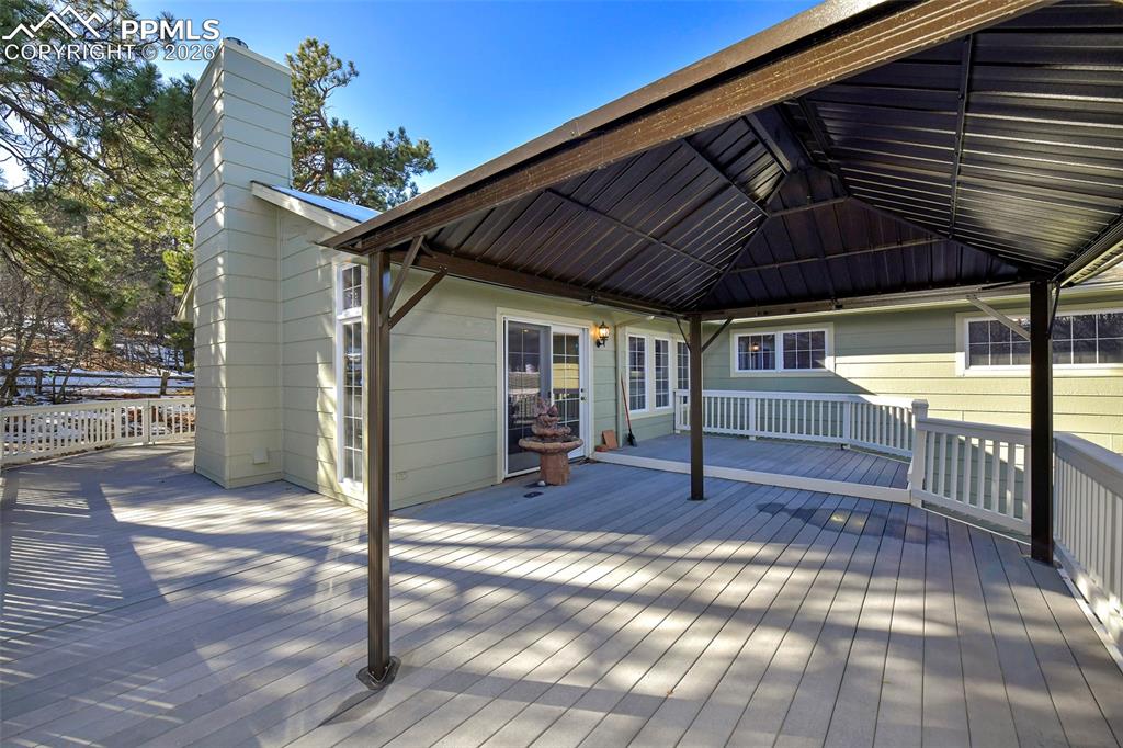 435 East Woodmen Road Colorado Springs, CO 80919 - Photo 9 of 50 a view of a backyard with a small deck and wooden floor
