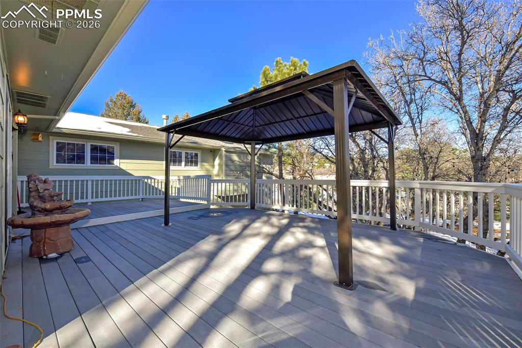 435 East Woodmen Road Colorado Springs, CO 80919 - Photo 10 of 50 a view of a house with wooden deck and furniture