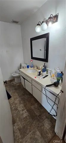 a bathroom with a sink vanity and mirror