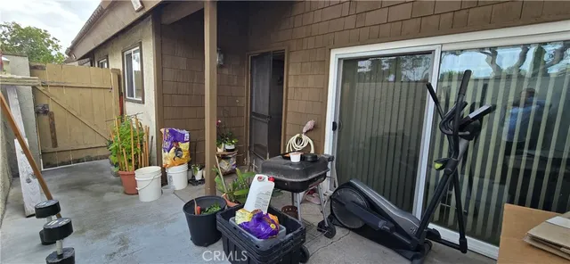 a view of a balcony with chairs and potted plants