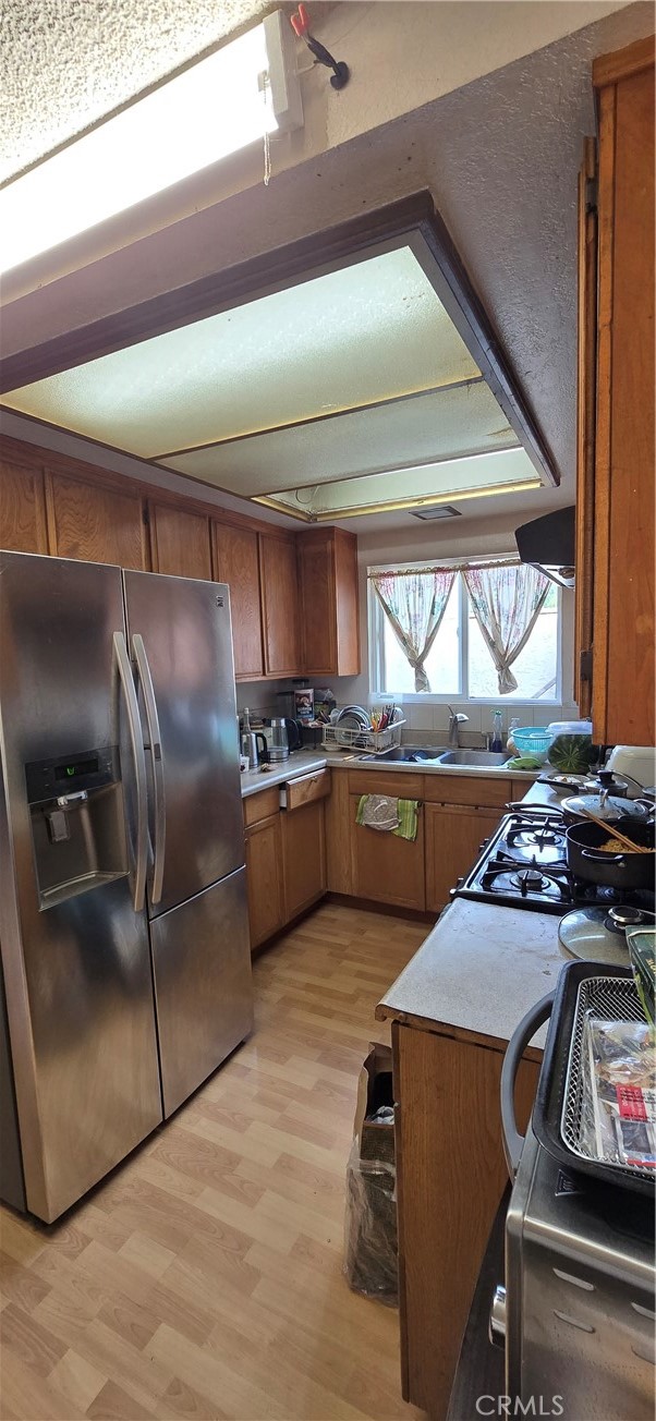 9370 Garden Grove Boulevard Garden Grove, CA 92844 - Photo 10 of 15 a kitchen with a stove a refrigerator and a stove