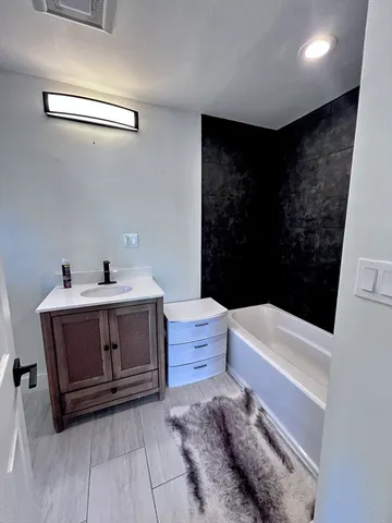 a bathroom with a sink a toilet and bathtub
