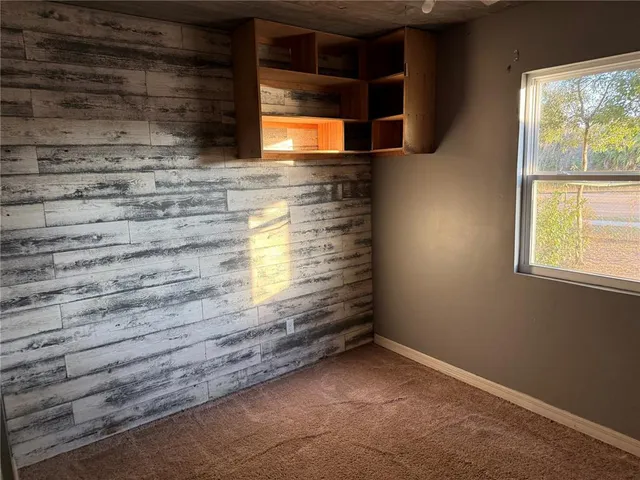a kitchen with a refrigerator a stove and a wooden floor