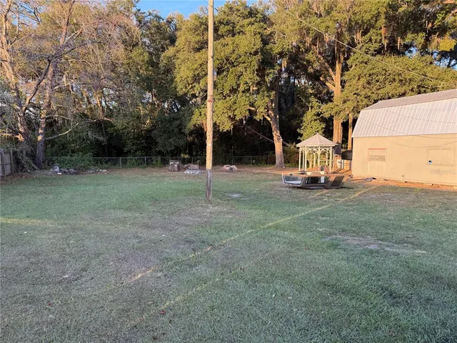 a view of a park with large trees