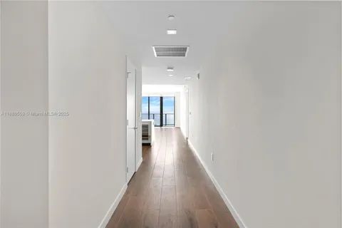 a view of a room with wooden floor and a window