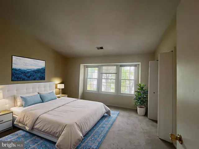 a spacious bedroom with a bed and a window