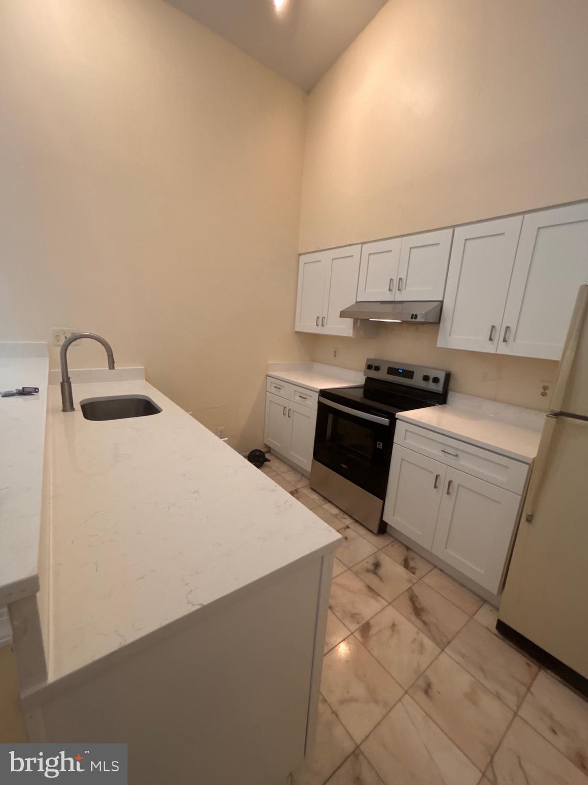 12889 C Grays Pointe Road, Unit 12889C Fairfax, VA 22033 - Photo 2 of 21 a kitchen with a sink a stove and cabinets