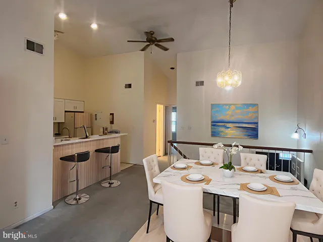 a room with a sink dishwasher a dining table and chairs