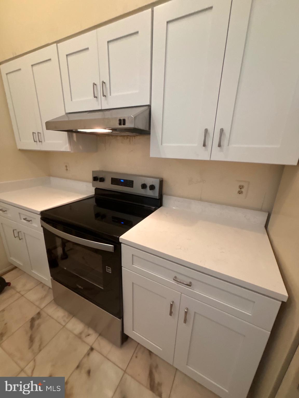 12889 C Grays Pointe Road, Unit 12889C Fairfax, VA 22033 - Photo 4 of 21 a kitchen with white cabinets and sink
