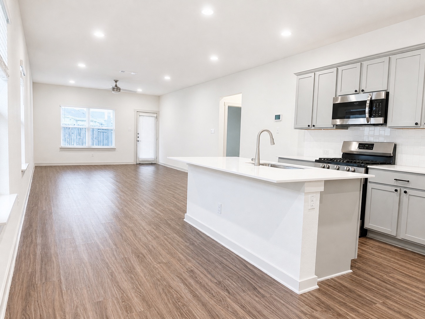 5128 Vanner Path Georgetown, TX 78626 - Photo 4 of 20 Open-concept living space featuring wood-finish flooring, recessed lighting, and a ceiling fan