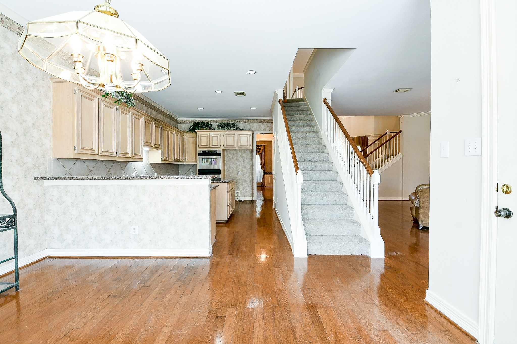 3003 Grand Noble Circle Houston, TX 77068 - Photo 14 of 32 a view of entryway and kitchen with wooden floor