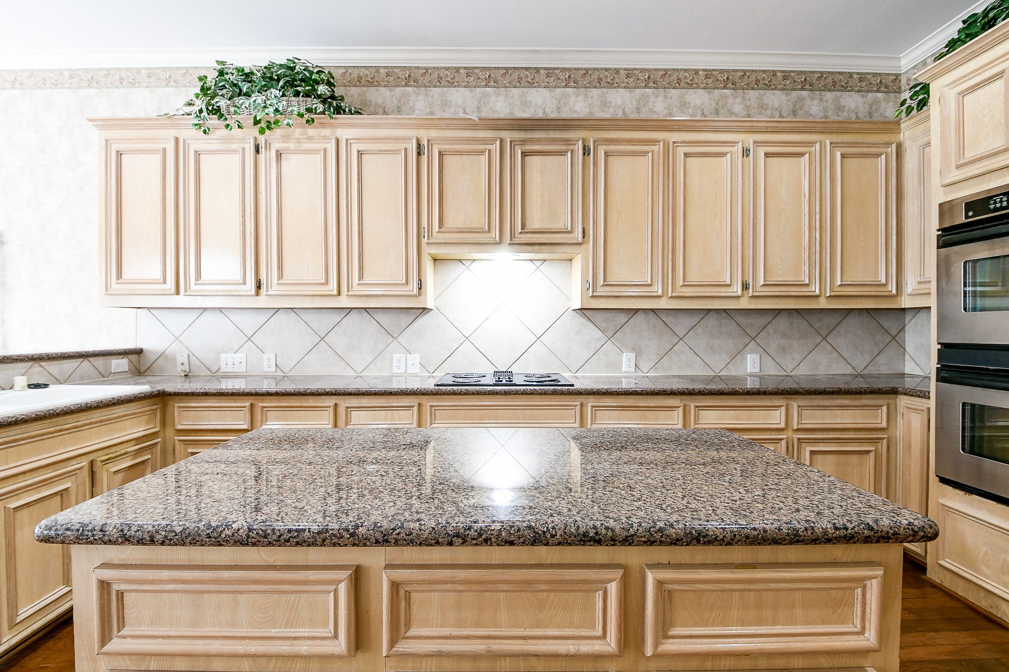 3003 Grand Noble Circle Houston, TX 77068 - Photo 16 of 32 a kitchen with granite countertop a sink a window and cabinets