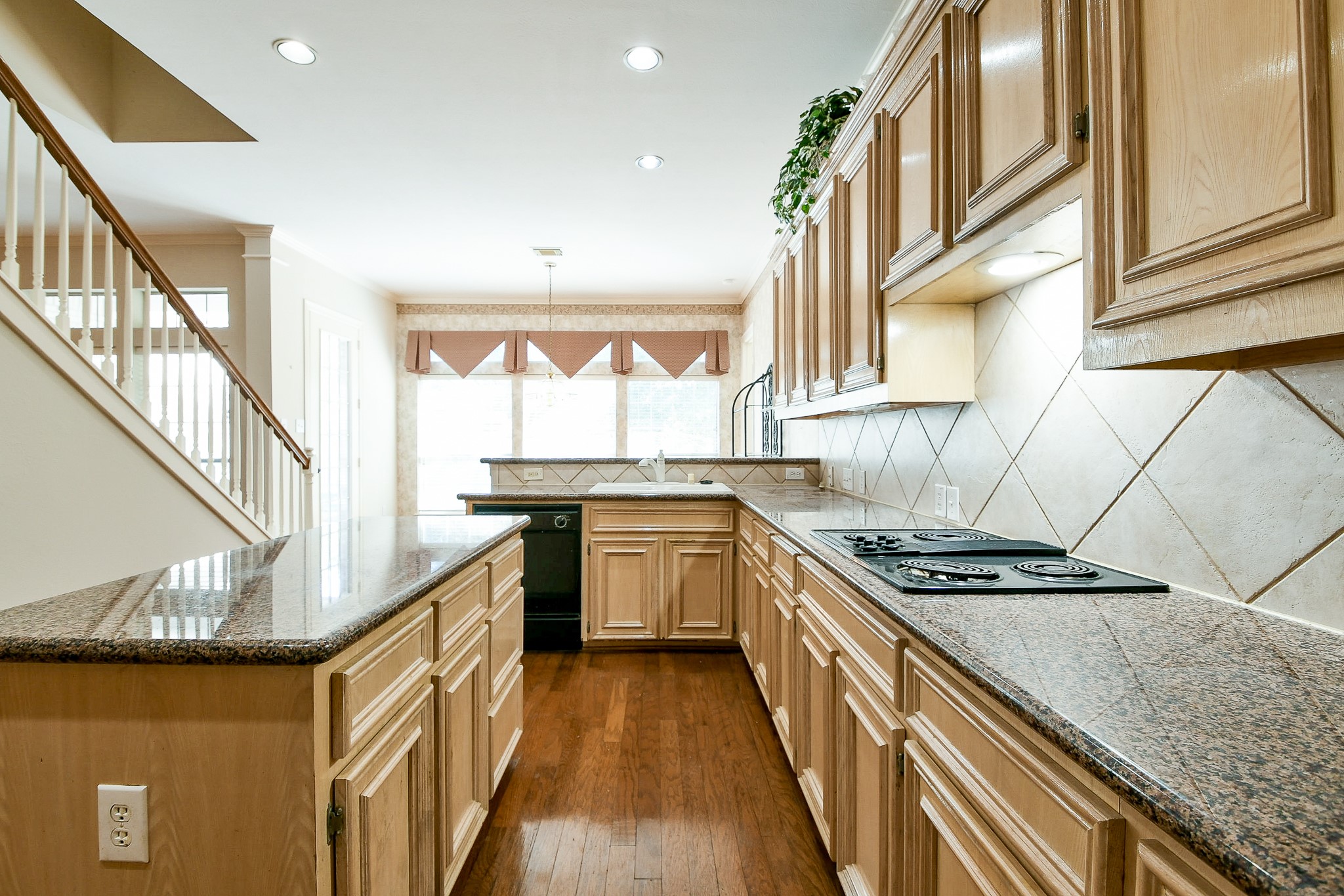 3003 Grand Noble Circle Houston, TX 77068 - Photo 17 of 32 a kitchen with granite countertop a stove and a sink