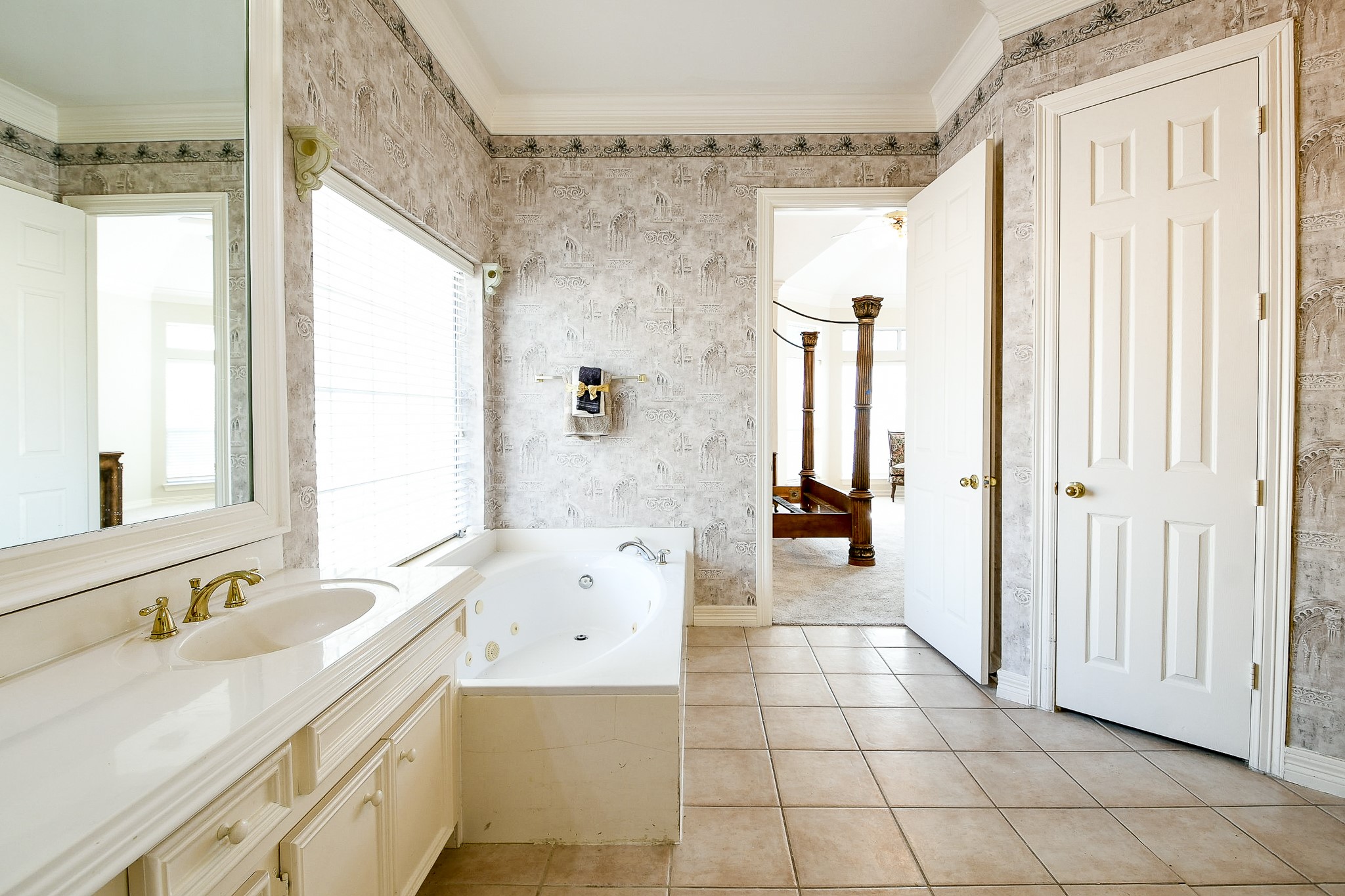 3003 Grand Noble Circle Houston, TX 77068 - Photo 20 of 32 a bathroom with a granite countertop sink a mirror and a bathtub