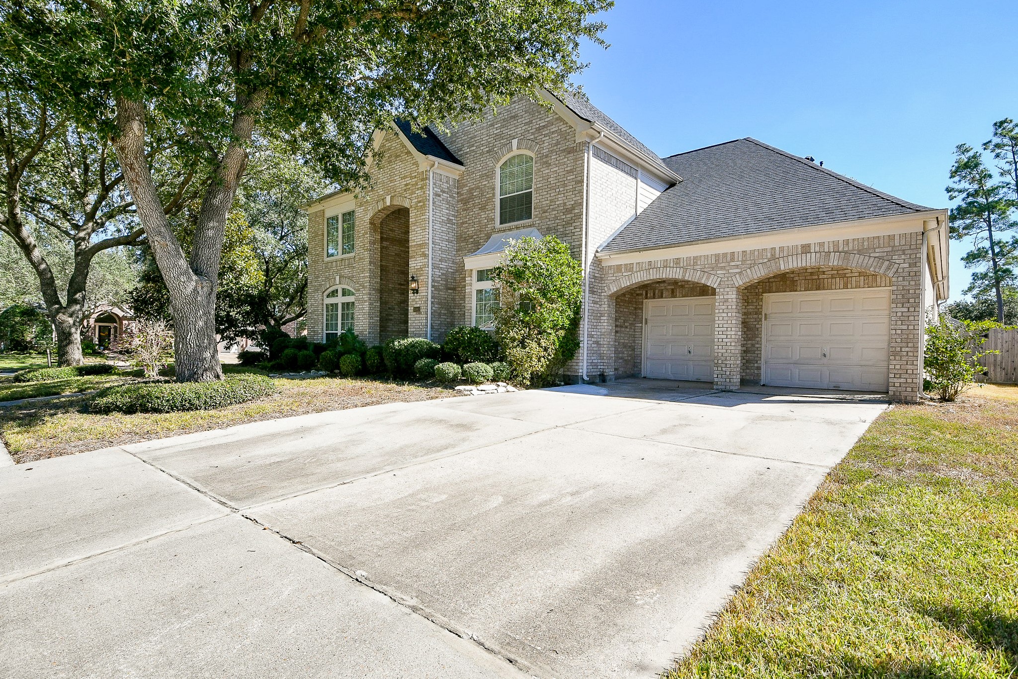 3003 Grand Noble Circle Houston, TX 77068 - Photo 2 of 32 a front view of a house with a yard and garage