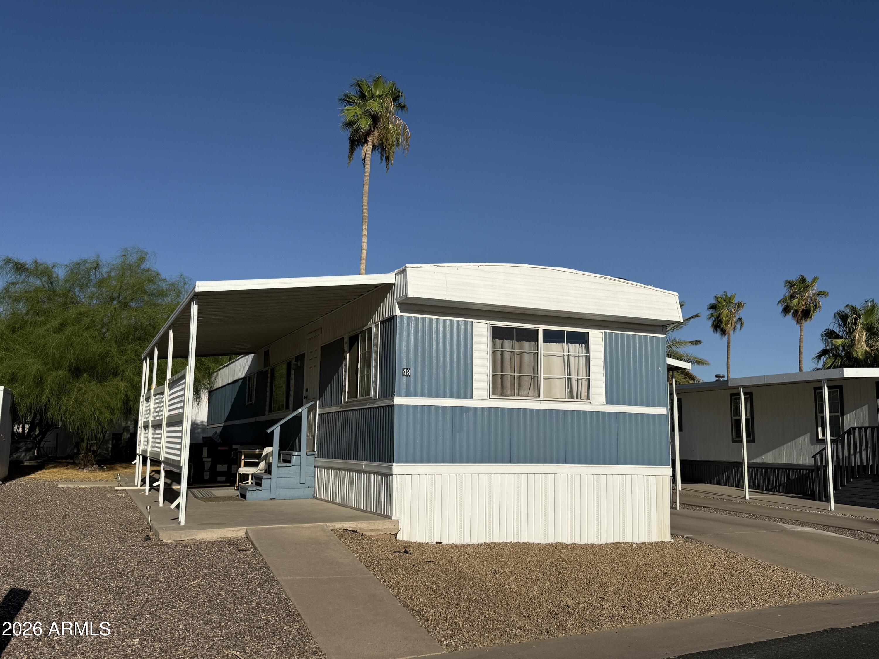 9501 East Broadway Road, Unit 48 Mesa, AZ 85208 - Photo 1 of 12 a front view of a house with a garage