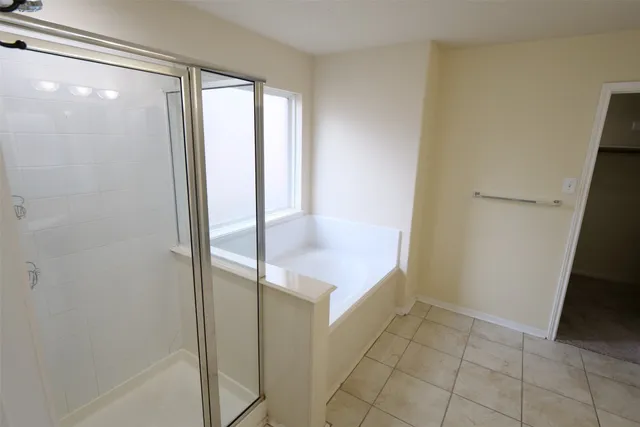 a bathroom with a glass shower door