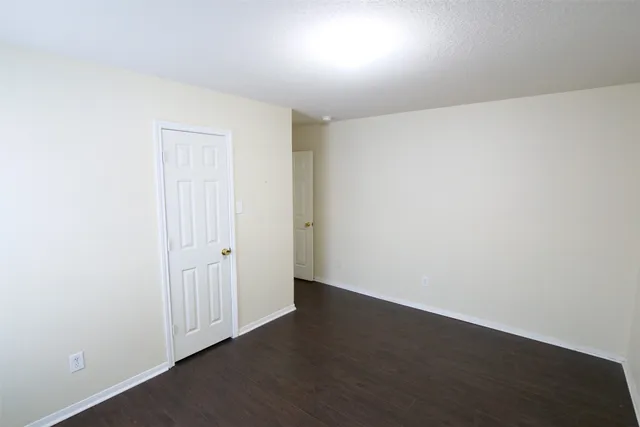 an empty room with wooden floor