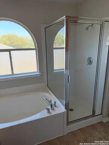 a bathroom with a bathtub and a shower